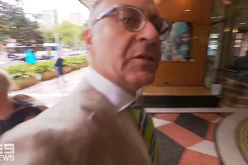 Andrew O'Keefe barged into a cameraman working for Channel Nine while entering court to face assault and resisting police charges