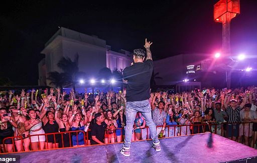 Jersey Shore star DJ PaulyD is pictured performing to a crowd of Spring Breakers in Mandala Beach, Cancun, Mexico